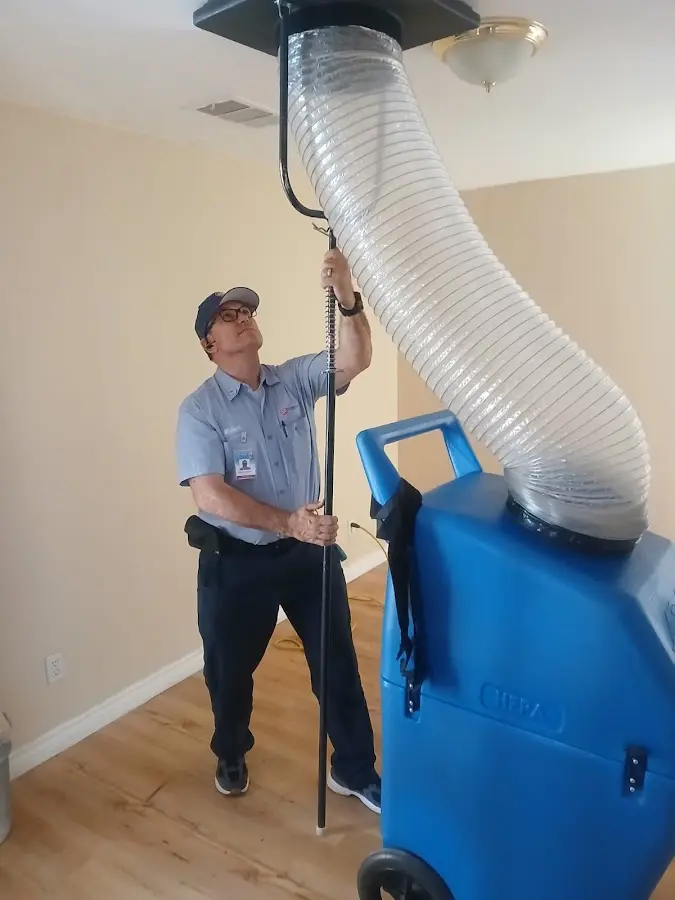 Furnace Tune-Up technician using HEPA equipment in Brea