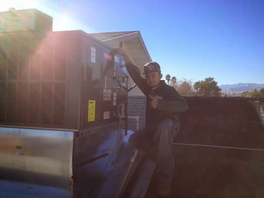 HVAC technician performing Heat Pump Repair on a rooftop unit in Brea